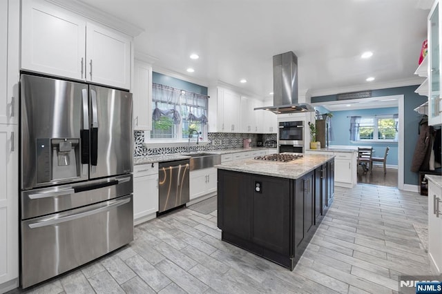 202 Elmwynd Dr, Orange, NJ 07050 - kitchen with stainless steel appliances, a sink, island range hood, ornamental molding, and white cabinets