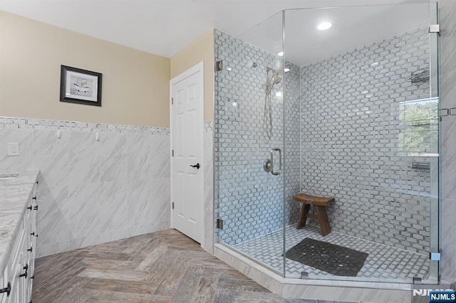 202 Elmwynd Dr, Orange, NJ 07050 - bathroom featuring tile walls, a shower stall, vanity, a wainscoted wall, and recessed lighting