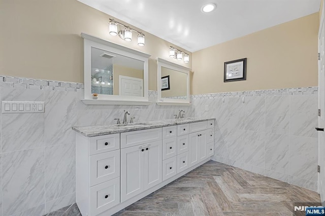202 Elmwynd Dr, Orange, NJ 07050 - full bathroom featuring tile walls, wainscoting, double vanity, and recessed lighting