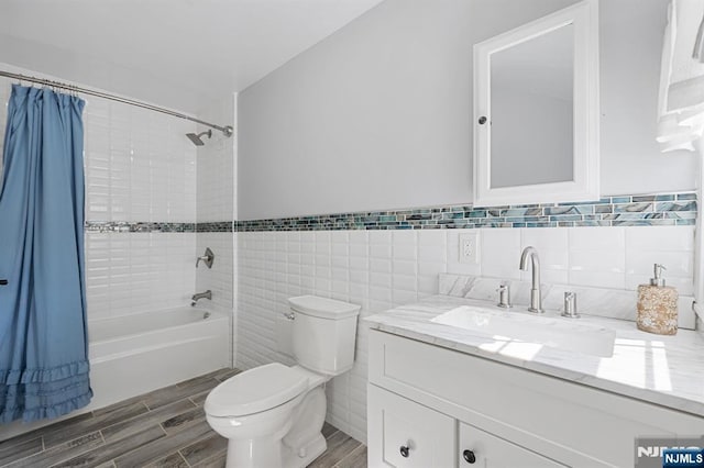 202 Elmwynd Dr, Orange, NJ 07050 - bathroom featuring toilet, shower / tub combo, vanity, wood finished floors, and tile walls