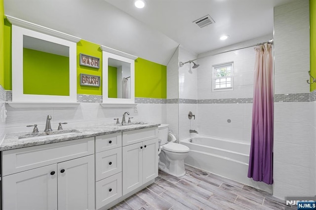 202 Elmwynd Dr, Orange, NJ 07050 - bathroom featuring tile walls, toilet, double vanity, shower / bath combination with curtain, and wood finished floors