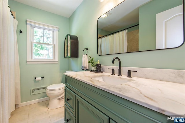 bathroom featuring tile patterned floors, toilet, vanity, and baseboards