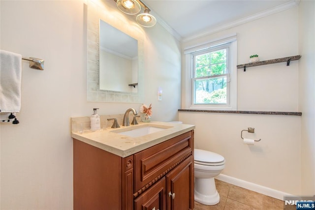 bathroom featuring crown molding, toilet, vanity, baseboards, and tile patterned floors