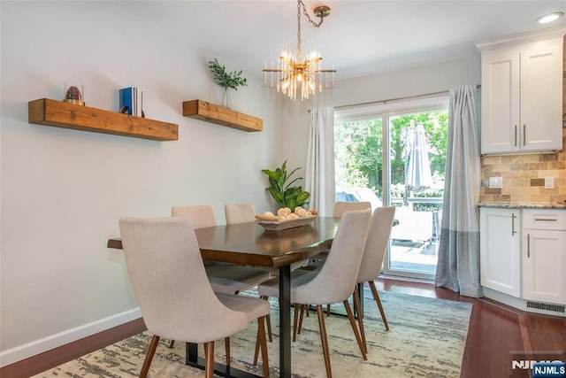 dining room featuring a chandelier, wood finished floors, baseboards, and recessed lighting