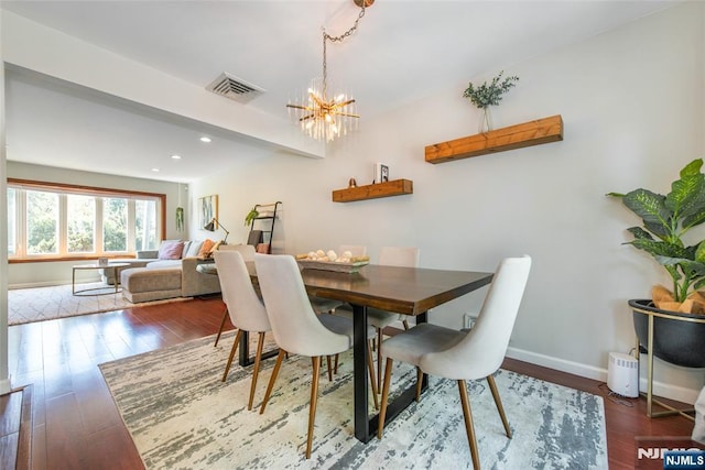 dining area featuring wood finished floors, a chandelier, baseboards, recessed lighting, and beamed ceiling
