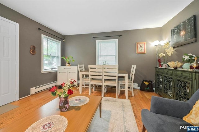 dining area with baseboard heating and wood finished floors