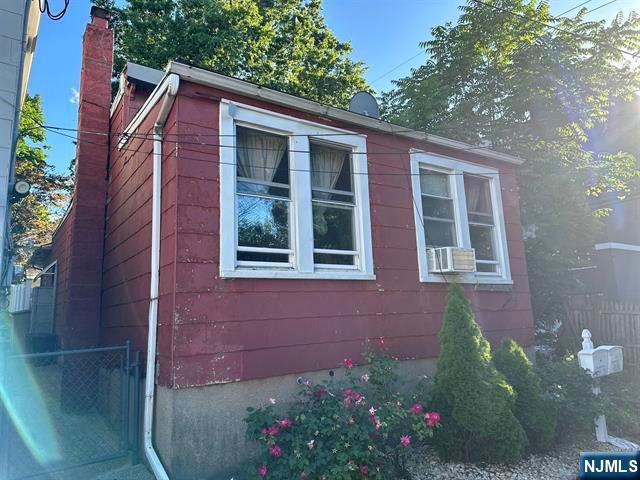3602 Liberty Ave, North Bergen, NJ 07047 - view of property exterior featuring fence and a chimney