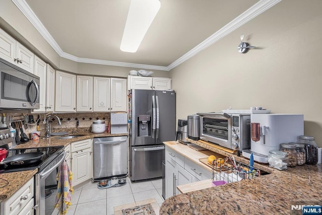 548 Windsor Dr Unit 548, Palisades Park, NJ 07650 - kitchen with stainless steel appliances, a sink, crown molding, light tile patterned floors, and white cabinets