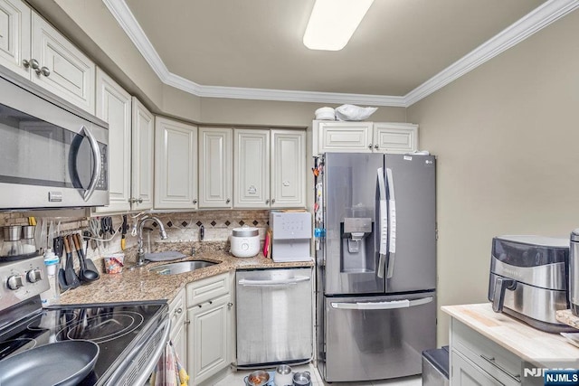 548 Windsor Dr Unit 548, Palisades Park, NJ 07650 - kitchen with stainless steel appliances, a sink, ornamental molding, tasteful backsplash, and white cabinetry