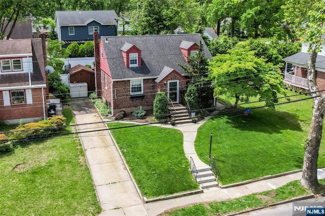 246 Baldwin Ave, New Milford, NJ 07646 - view of front facade with brick siding, driveway, an outdoor structure, and a shingled roof