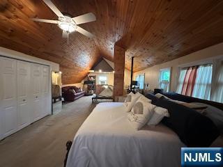 bedroom with wood ceiling and vaulted ceiling
