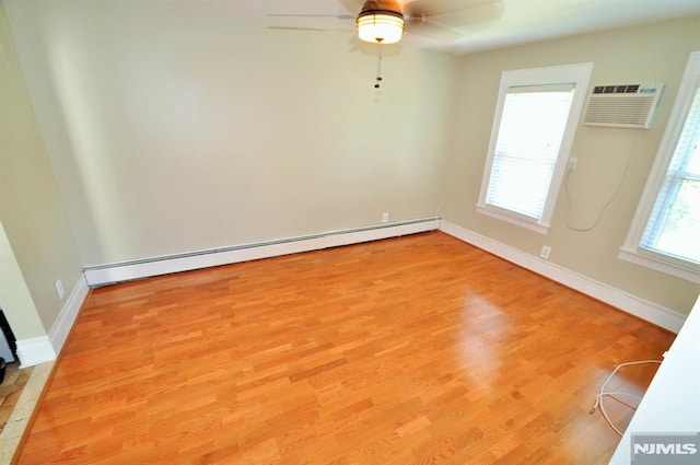 79 Arthur St, Ridgefield Park, NJ 07660 - spare room with a baseboard radiator, a wall mounted air conditioner, light wood-style flooring, a ceiling fan, and baseboards