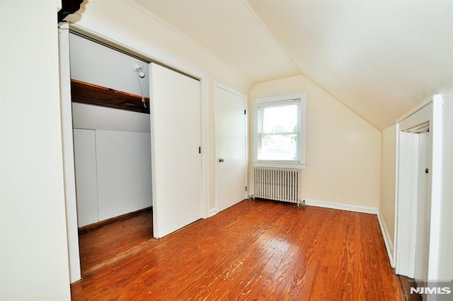 79 Arthur St, Ridgefield Park, NJ 07660 - bonus room featuring radiator heating unit, wood finished floors, and vaulted ceiling