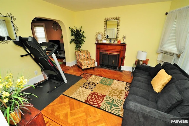 79 Arthur St, Ridgefield Park, NJ 07660 - living area with arched walkways, a fireplace with flush hearth, baseboards, and cooling unit