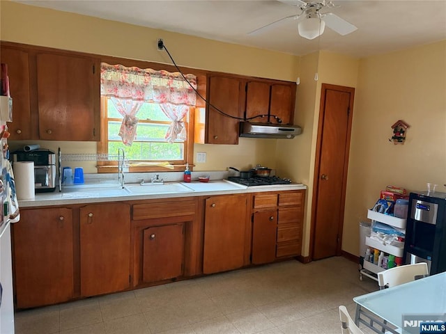 33 E Joseph St, Moonachie, NJ 07074 - kitchen featuring light countertops, under cabinet range hood, and brown cabinetry