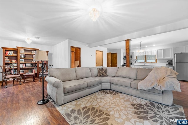 living room featuring wood finished floors and ornate columns