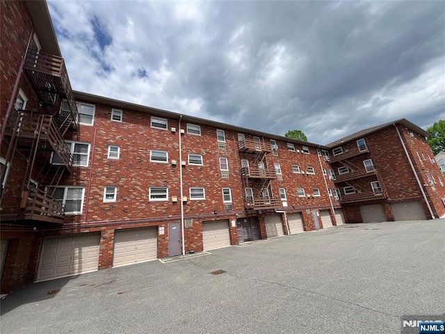 2430 8th St Unit 5B, Fort Lee, NJ 07024 - view of apartment building / complex featuring a garage and driveway