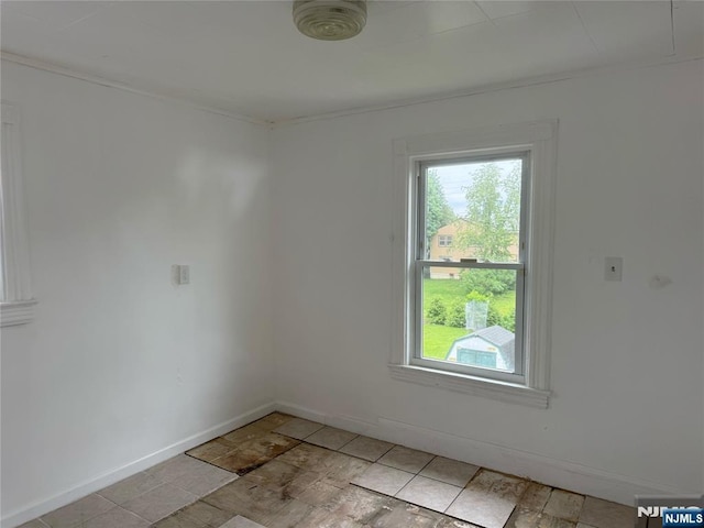 unfurnished room featuring baseboards