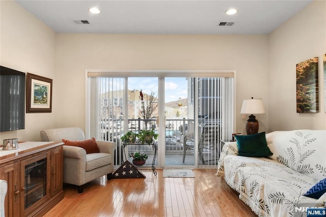 living room with light wood-style floors and recessed lighting