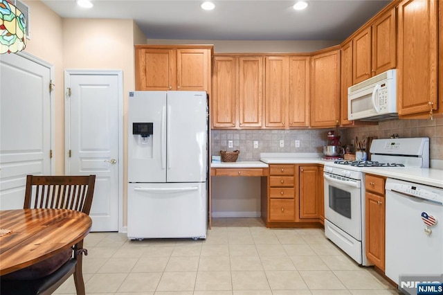 kitchen featuring white appliances, light countertops, tasteful backsplash, recessed lighting, and brown cabinets