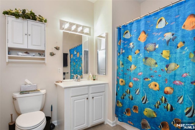 bathroom featuring vanity, toilet, baseboards, tile patterned floors, and curtained shower
