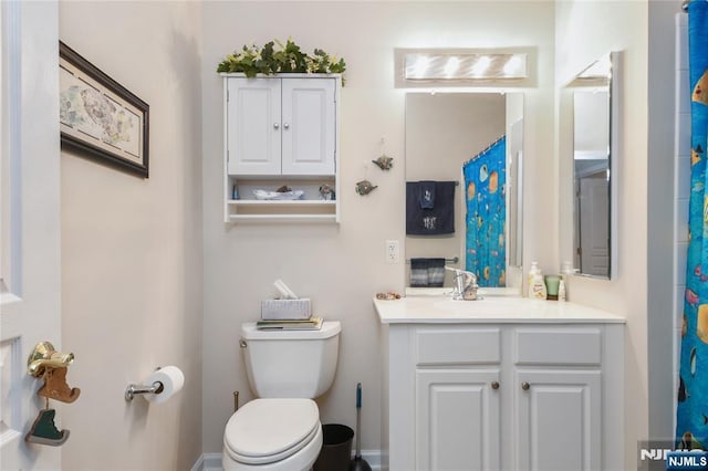 full bathroom with toilet and vanity
