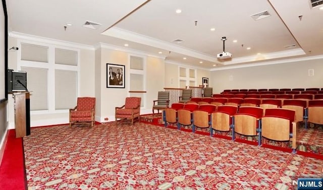 carpeted cinema featuring a raised ceiling, ornamental molding, and recessed lighting