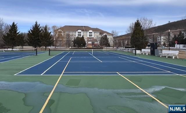 view of tennis court with fence