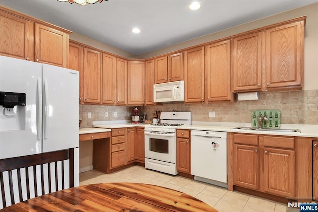 kitchen featuring white appliances, light tile patterned floors, tasteful backsplash, light countertops, and recessed lighting