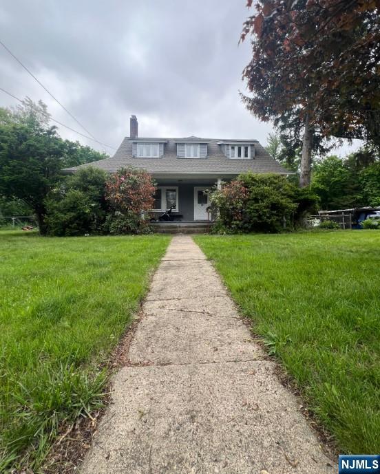 247 Ramapo Valley Rd, Oakland, NJ 07436 - bungalow-style house featuring a porch, a front yard, and a chimney