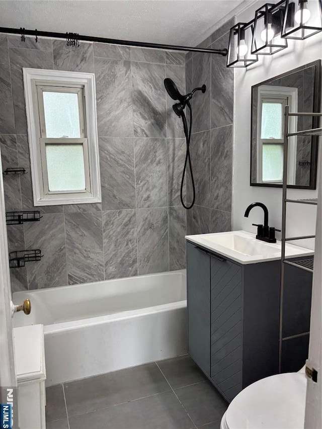 full bath with tile patterned flooring, shower / bathtub combination, toilet, a textured ceiling, and vanity