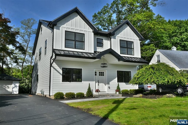 14 Charles Ter, Waldwick, NJ 07463 - modern farmhouse with board and batten siding, a standing seam roof, a front lawn, metal roof, and an outdoor structure