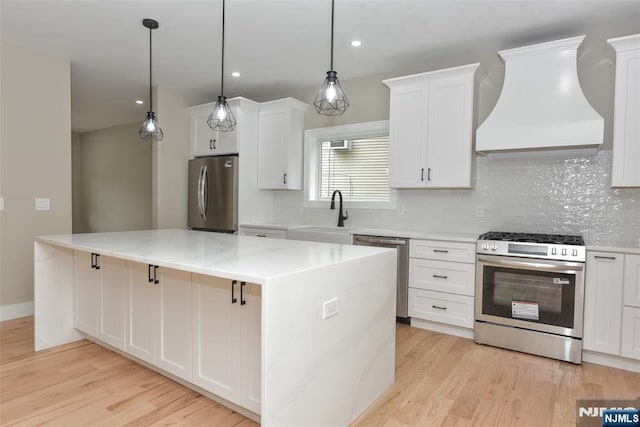 14 Charles Ter, Waldwick, NJ 07463 - kitchen featuring stainless steel appliances, wall chimney exhaust hood, a sink, light wood finished floors, and recessed lighting