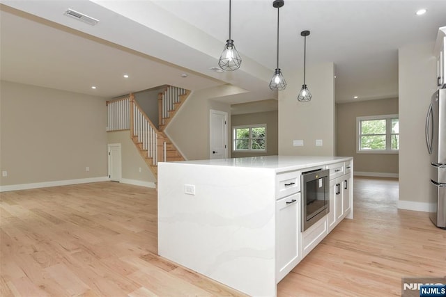 14 Charles Ter, Waldwick, NJ 07463 - kitchen with white cabinetry, hanging light fixtures, open floor plan, light wood-style flooring, and recessed lighting