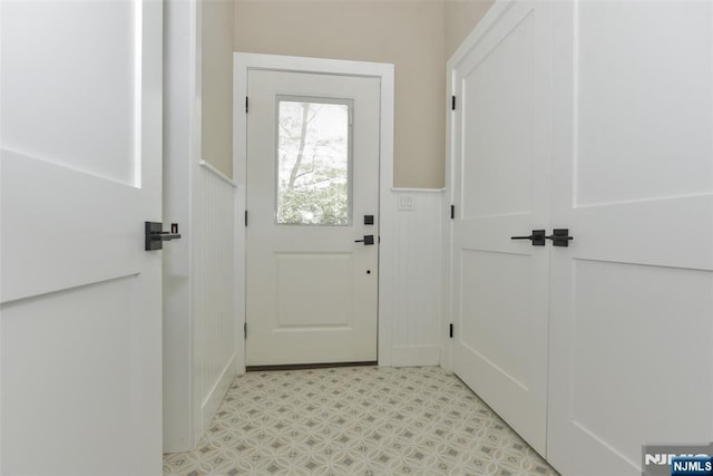 14 Charles Ter, Waldwick, NJ 07463 - doorway to outside with a wainscoted wall, light flooring, and a decorative wall