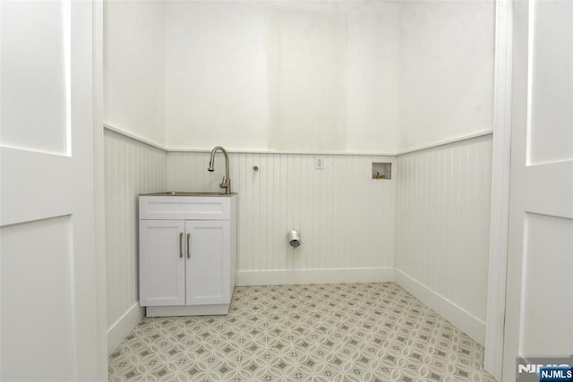 14 Charles Ter, Waldwick, NJ 07463 - laundry area featuring wainscoting, cabinet space, light flooring, and baseboards