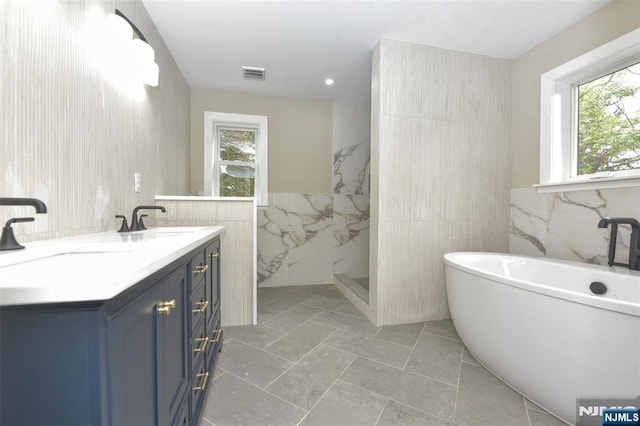 14 Charles Ter, Waldwick, NJ 07463 - full bath featuring tile walls, a freestanding tub, a marble finish shower, and double vanity