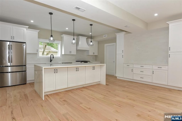 14 Charles Ter, Waldwick, NJ 07463 - kitchen featuring freestanding refrigerator, wall chimney range hood, decorative backsplash, light wood-style flooring, and recessed lighting