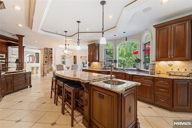 14 Stewart Ct, Old Tappan, NJ 07675 - kitchen with a raised ceiling, a sink, tasteful backsplash, light stone counters, and recessed lighting