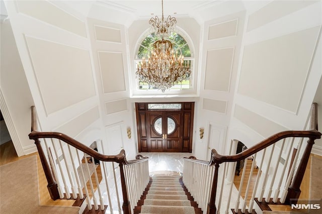 14 Stewart Ct, Old Tappan, NJ 07675 - entryway with a chandelier, stairs, a towering ceiling, and wood finished floors
