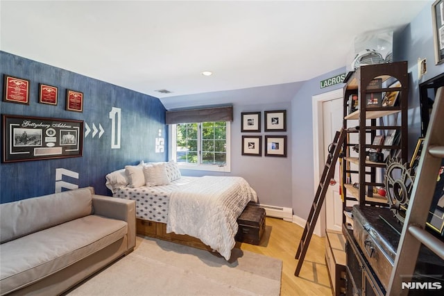 14 Stewart Ct, Old Tappan, NJ 07675 - bedroom with baseboard heating, light wood-type flooring, baseboards, and an accent wall