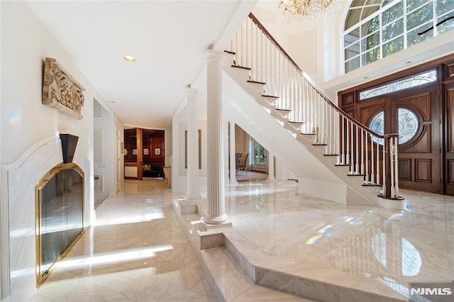 14 Stewart Ct, Old Tappan, NJ 07675 - entrance foyer featuring marble tiled flooring, ornate columns, plenty of natural light, a towering ceiling, and recessed lighting