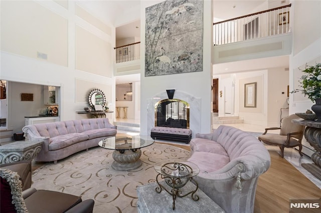 14 Stewart Ct, Old Tappan, NJ 07675 - living room featuring a towering ceiling, a multi sided fireplace, and wood finished floors