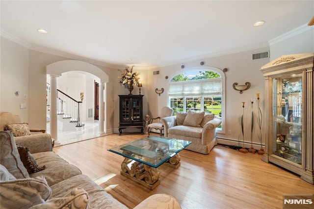 14 Stewart Ct, Old Tappan, NJ 07675 - living area with decorative columns, arched walkways, light wood finished floors, crown molding, and stairway