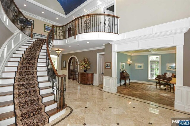 70 Oak Dr, Upper Saddle River, NJ 07458 - entryway featuring a towering ceiling, ornamental molding, stairs, recessed lighting, and marble tiled flooring