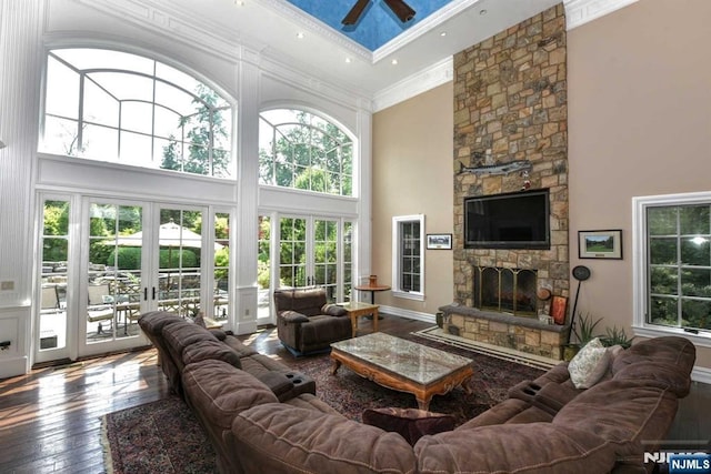 70 Oak Dr, Upper Saddle River, NJ 07458 - living room with a towering ceiling, ceiling fan, a fireplace, wood-type flooring, and ornamental molding
