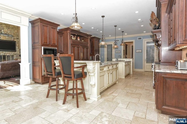 70 Oak Dr, Upper Saddle River, NJ 07458 - kitchen with stone tile floors, a spacious island, recessed lighting, cream cabinetry, and ornamental molding