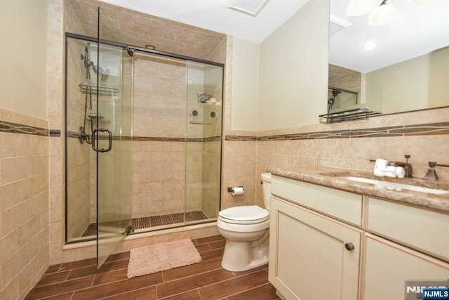 70 Oak Dr, Upper Saddle River, NJ 07458 - full bath with tile walls, vanity, toilet, a shower stall, and wood finish floors