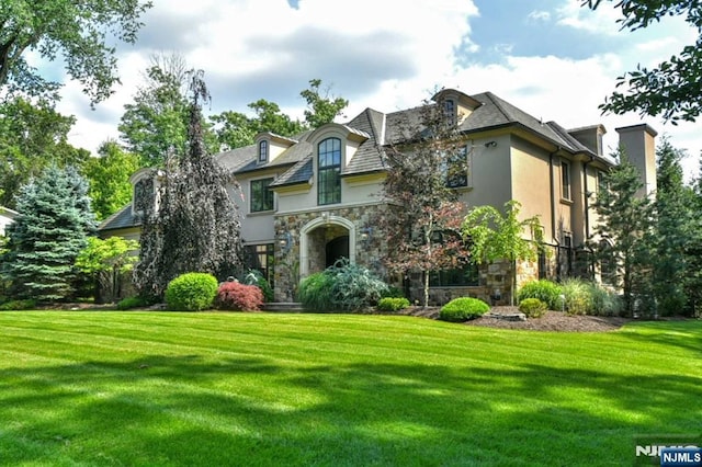 70 Oak Dr, Upper Saddle River, NJ 07458 - french country home featuring stone siding, stucco siding, and a front lawn