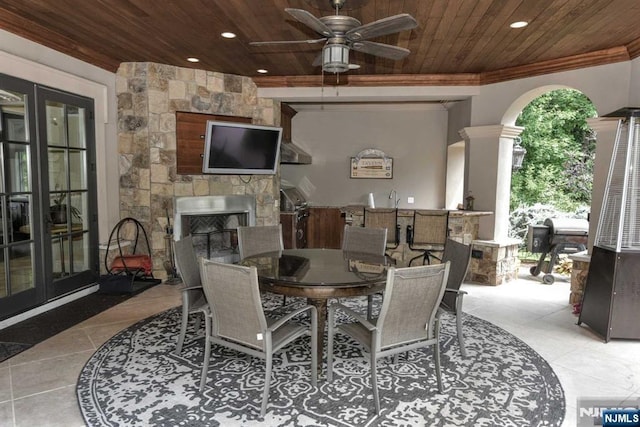 70 Oak Dr, Upper Saddle River, NJ 07458 - tiled dining room with wood ceiling, ceiling fan, an outdoor stone fireplace, recessed lighting, and crown molding